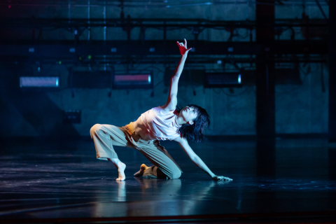 Dancer with arm stretched up in the air