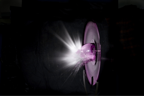 A glass bulb shattering in the dark